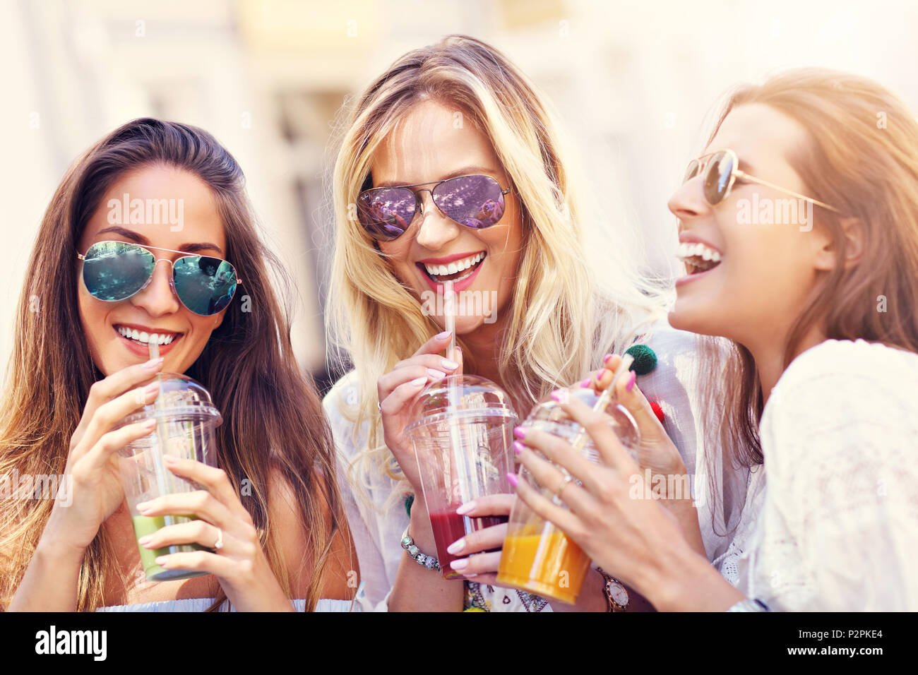 Happy girl friends hanging out in the city in summer Stock Photo - Alamy