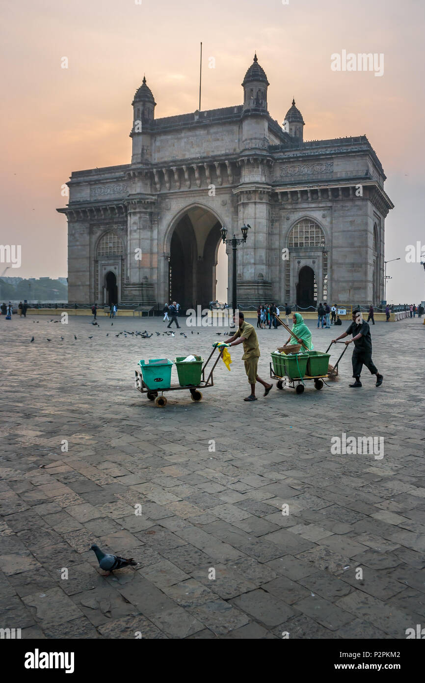 MUMBAI, INDIA - JANUARY 14, 2017 -  Sweepers walking in front of Gateway of India after cleaning streets of Mumbai Stock Photo