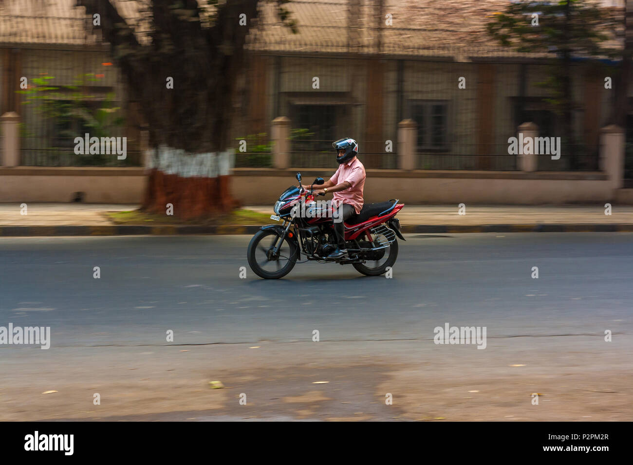 MUMBAI, INDIA - DECEMBER 04, 2016 : A man riding a motor bike on streets of Mumbai Stock Photo