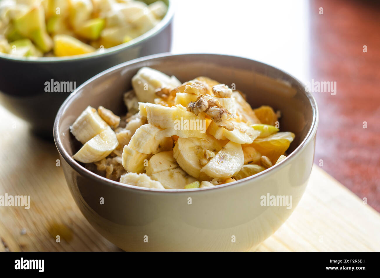 Healthy Breakfast Bowl Oatmeal with Banana, Orange, Green Apple