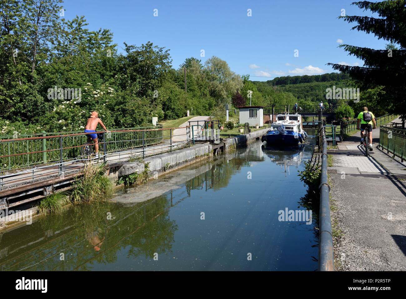 France, Doubs, Allenjoie, canal bridge, the Rhone-Rhine canal crosses the Allan and joins the Haute Saone canal, a barge comes out of the lock, bike paths, bicycles Stock Photo