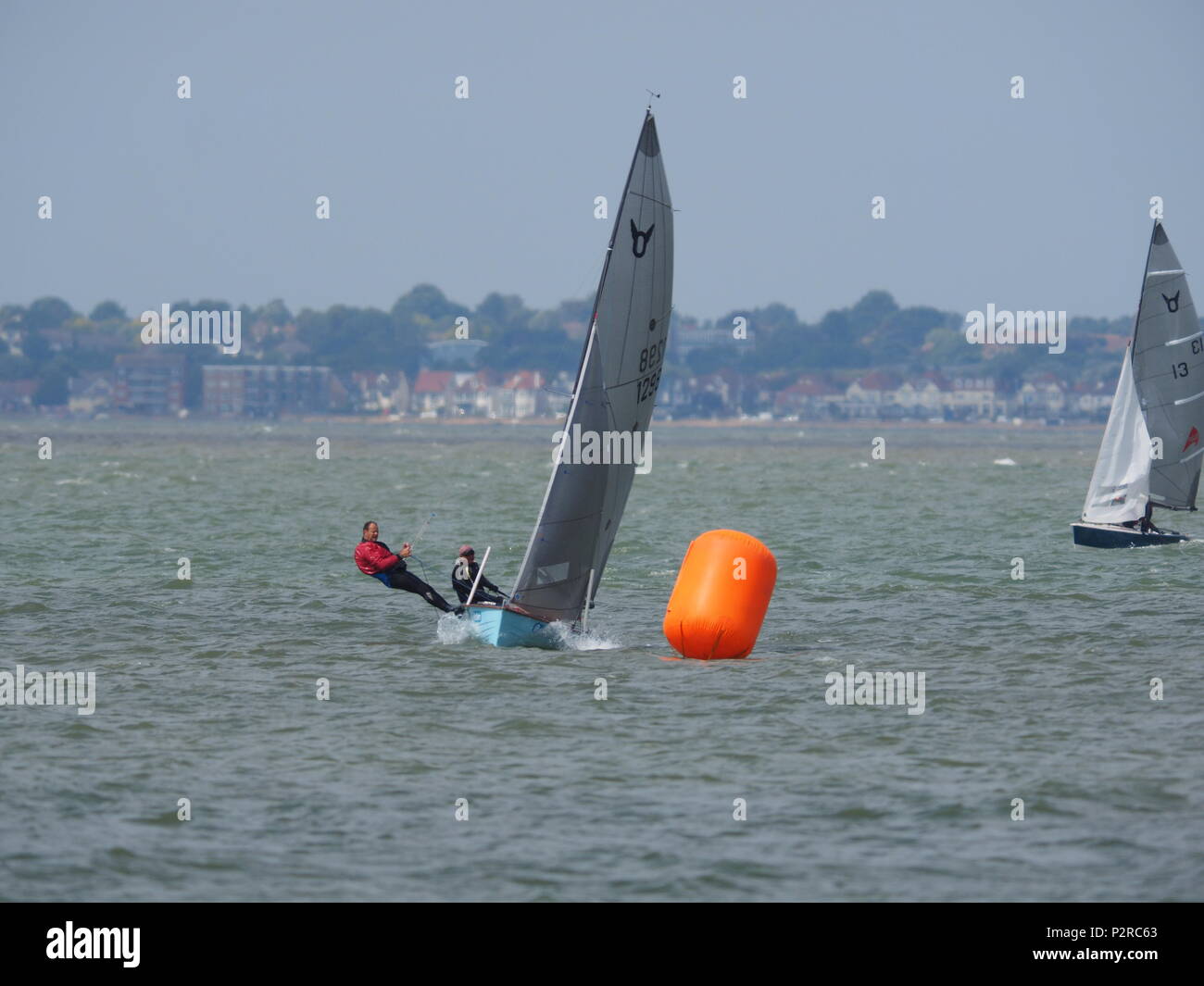 Sheerness, Kent, UK. 16th June, 2018. UK Weather: a warm day of mostly sunny spells, but with a few overcast moments in Sheerness, Kent. Sailors take part in a weekend regatta for the Osprey class of sailing dinghy at the Isle of Sheppey Sailing Club. Credit: James Bell/Alamy Live News Stock Photo