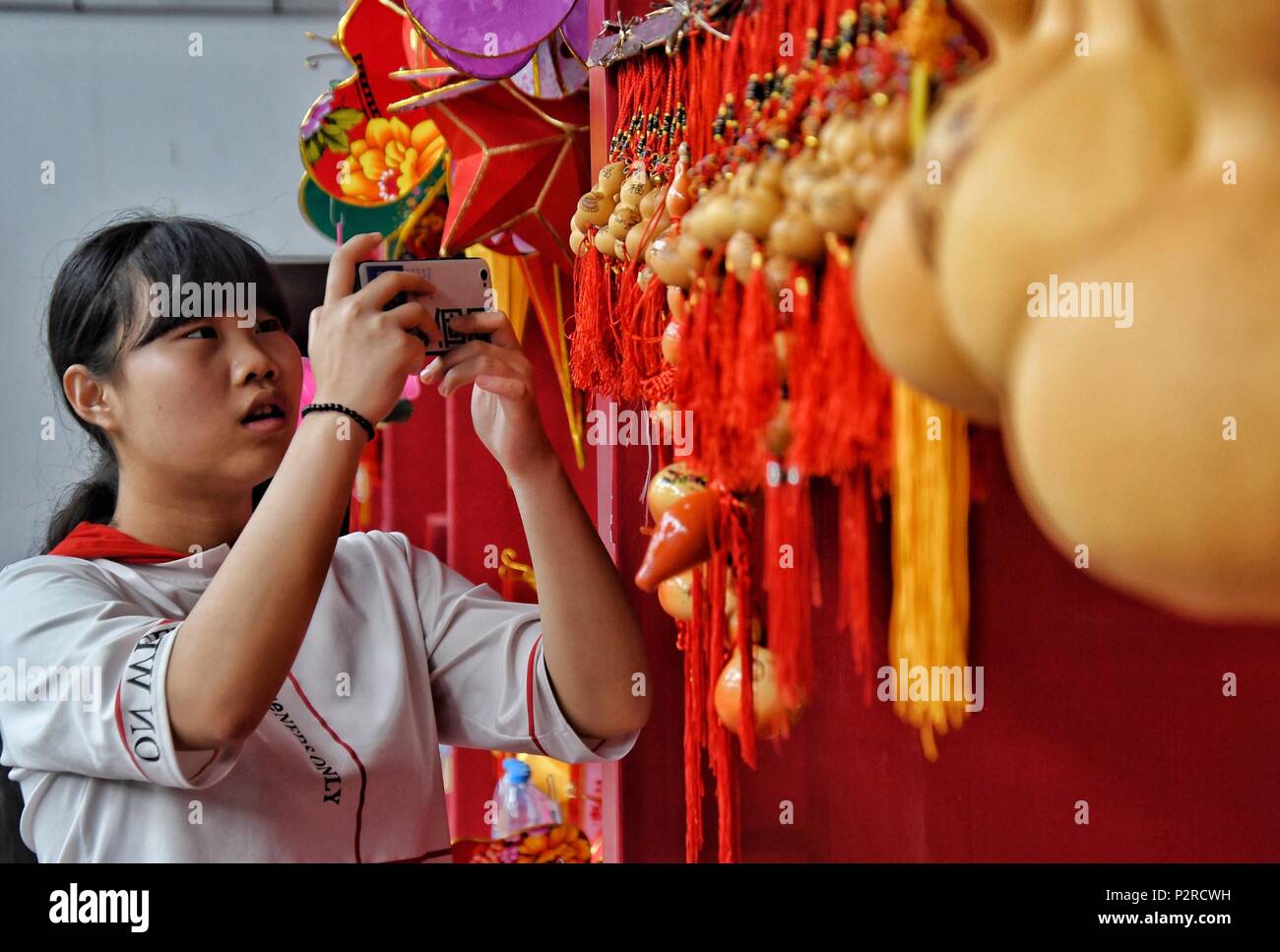 Beijing, China. 16th June, 2018. A citizen takes photos of calabash handicrafts during a cultural festival of the Dragon Boat Festival in Yanqing District of Beijing, capital of China, June 16, 2018. Credit: Li Xin/Xinhua/Alamy Live News Stock Photo