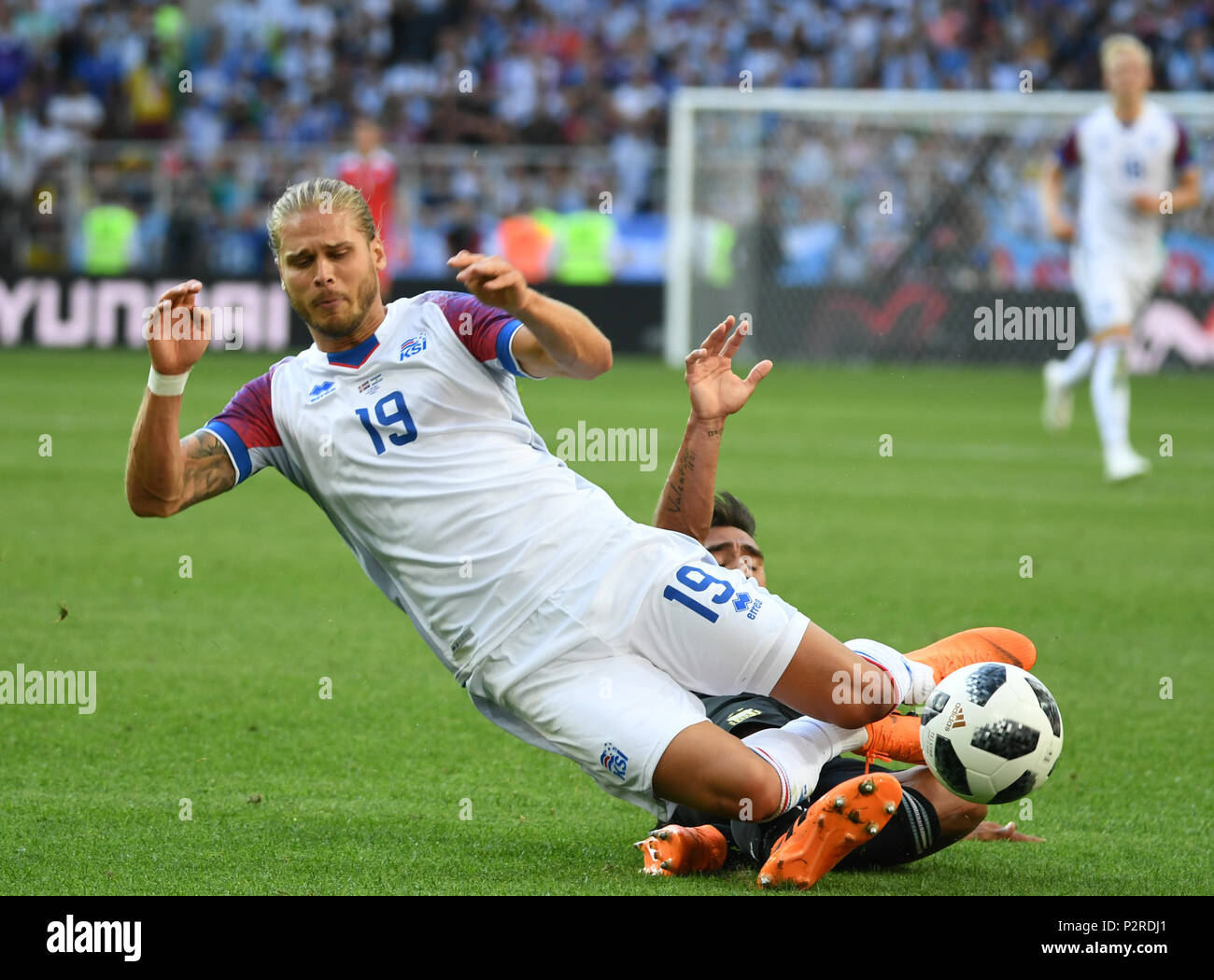 Moscow, Russia. 16th June, 2018. Rurik Gislason (front) of Iceland falls down during a group D match between Argentina and Iceland at the 2018 FIFA World Cup in Moscow, Russia, June 16, 2018. Credit: Du Yu/Xinhua/Alamy Live News Stock Photo