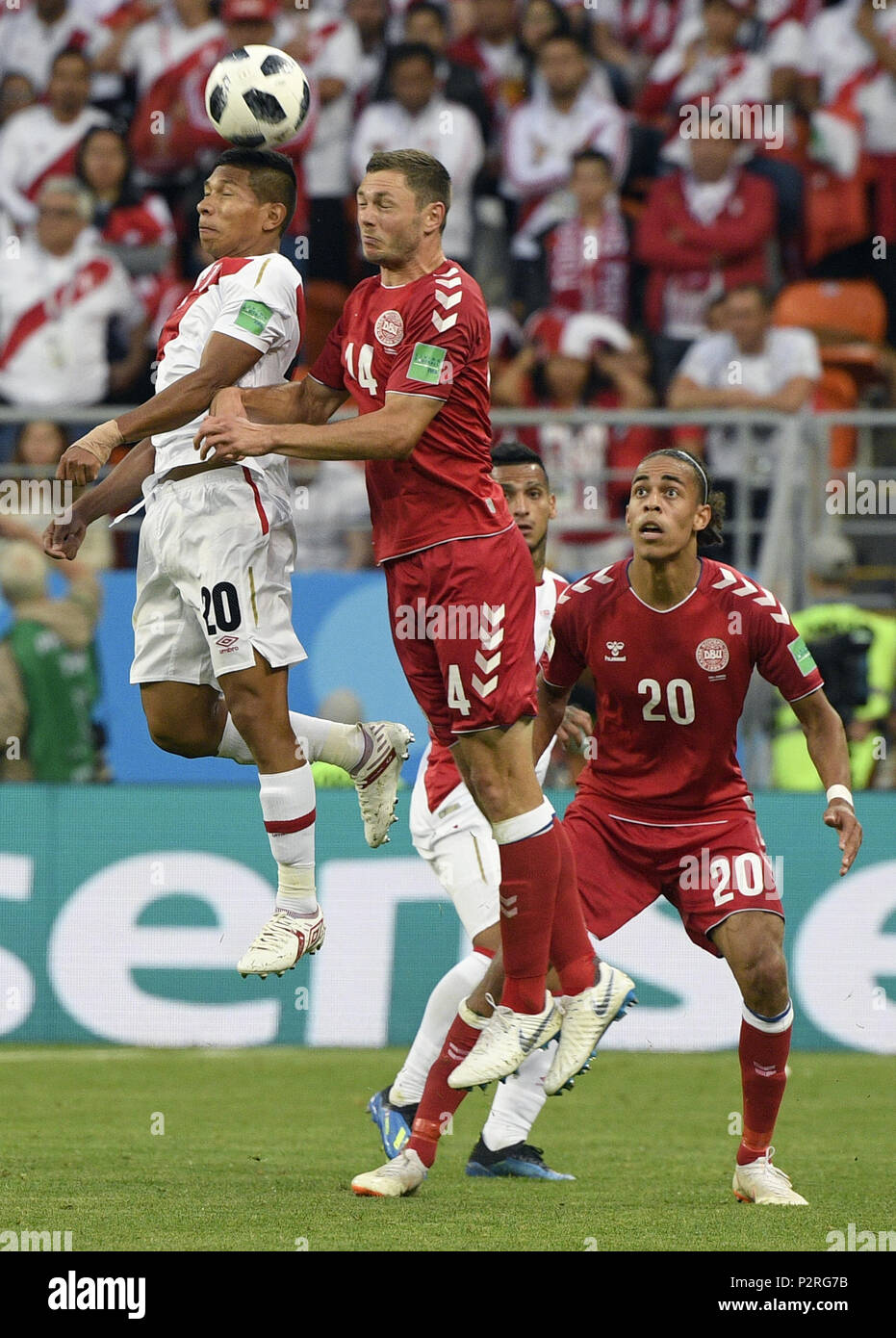 Saransk, Russia. 16th June, 2018. Edison Flores (1st L) of Peru competes for a head ball with Henrik Dalsgaard (2nd L) of Denmark during a group C match between Peru and Denmark at the 2018 FIFA World Cup in Saransk, Russia, June 16, 2018. Credit: Lui Siu Wai/Xinhua/Alamy Live News Stock Photo