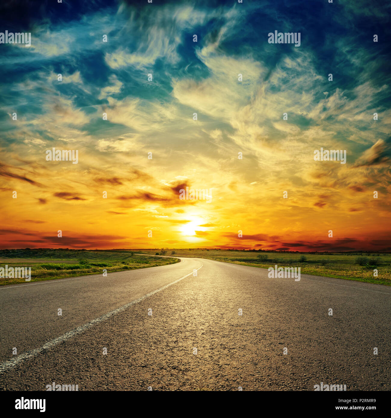 low orange sun over asphalt road Stock Photo - Alamy