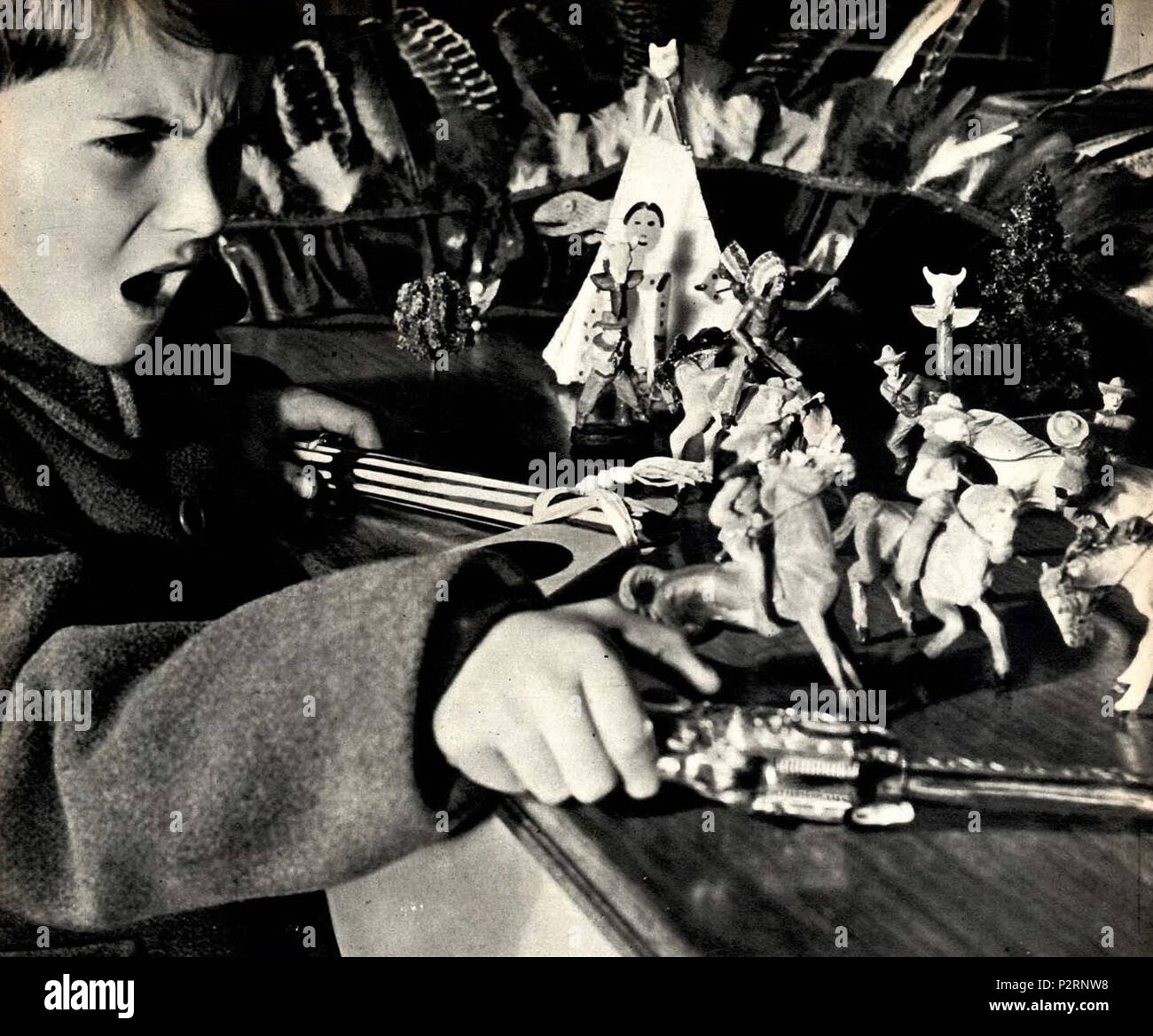 . Child playing with tin soldiers . 22 December 1951. Unknown 1 1951 child playing with tin soldiers Stock Photo