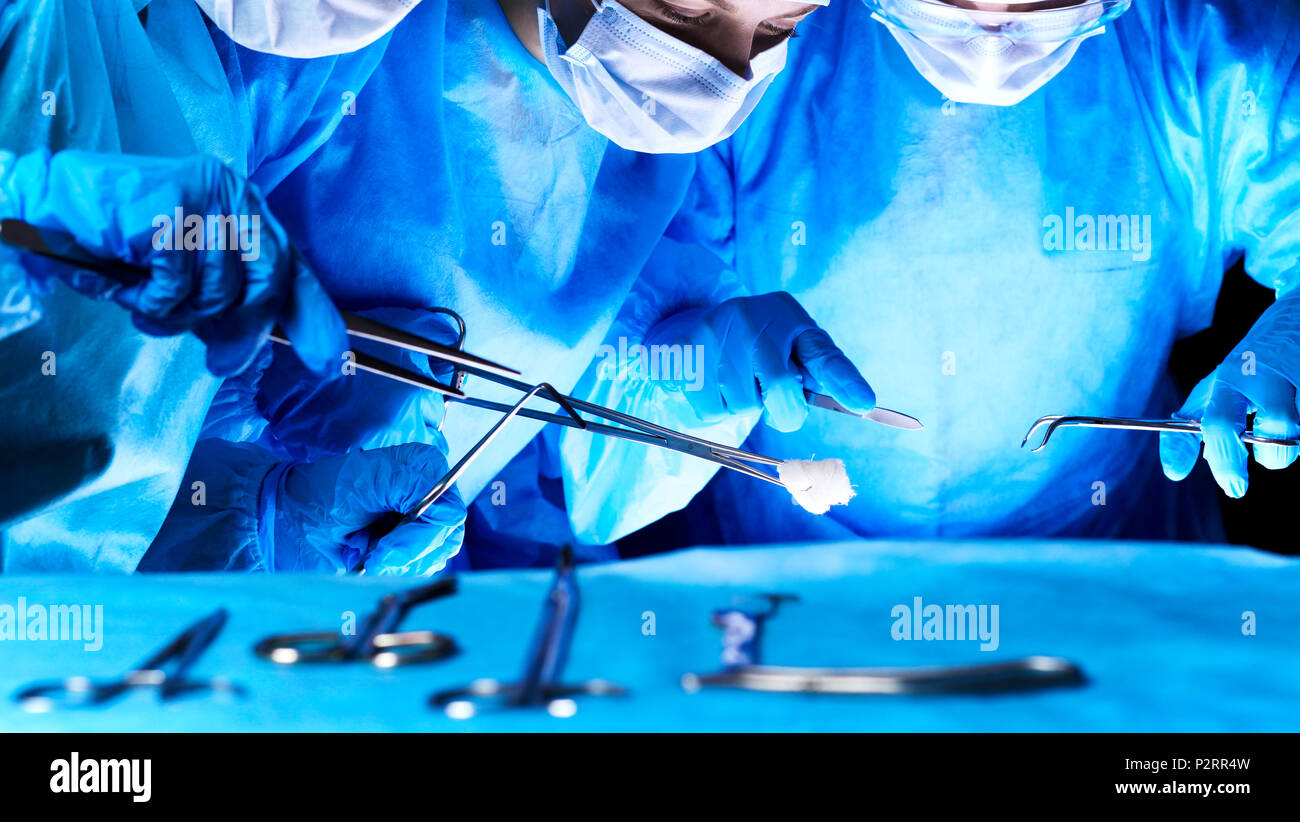 Group of surgeons in masks performing operation. Medicine, surgery and ...