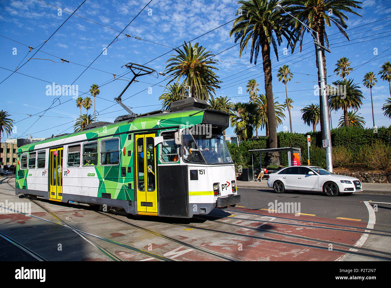Melbourne, Australia: April 09, 2018: A tram leaves the Acland Street tram stop in St Kilda. The public transport system runs through the suburbs. Stock Photo