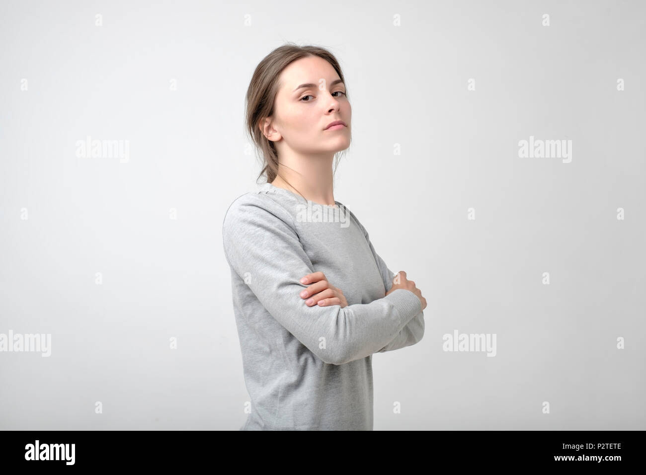 The young woman portrait with proud and arrogant emotions on face. She is self proud and does not care about other people Stock Photo