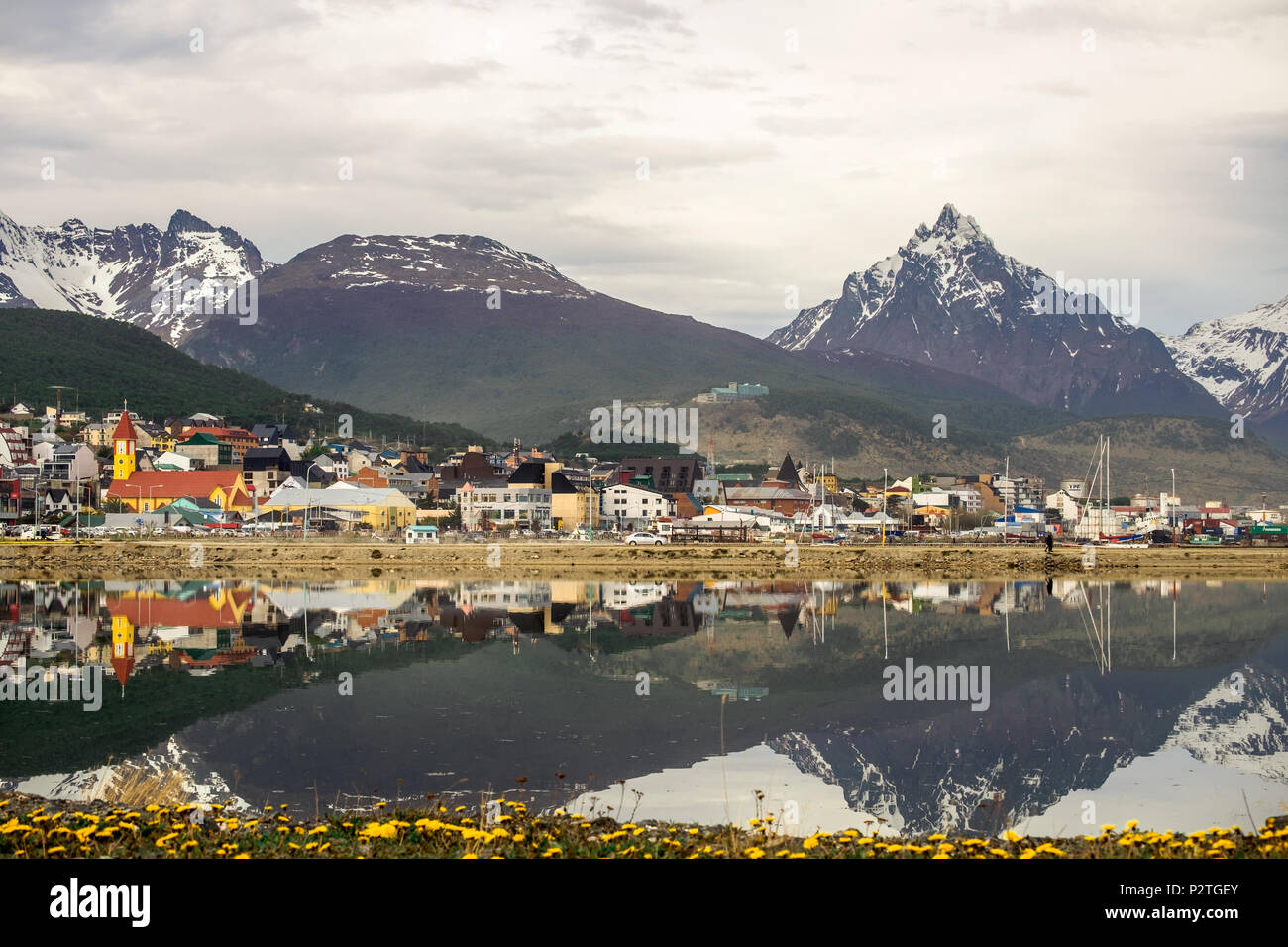 The 'Bahía Encerrada' mirrors the city of Ushuaia and its surrounding mountains. The scenery of this southernmost city is extraordinary. Stock Photo