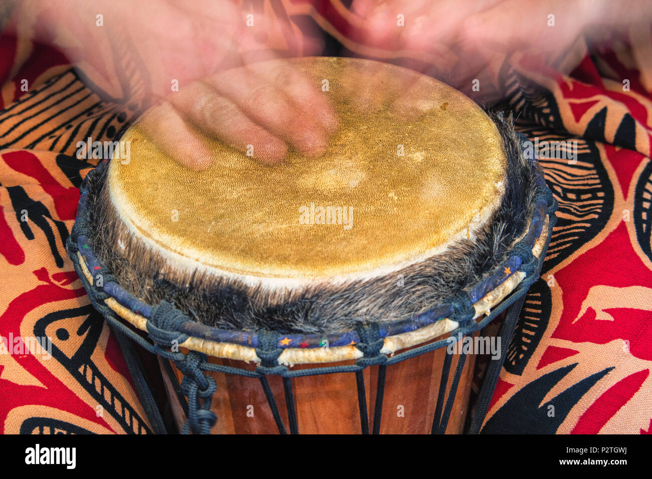 capturing motion of someone drumming on an ethnic drum Stock Photo