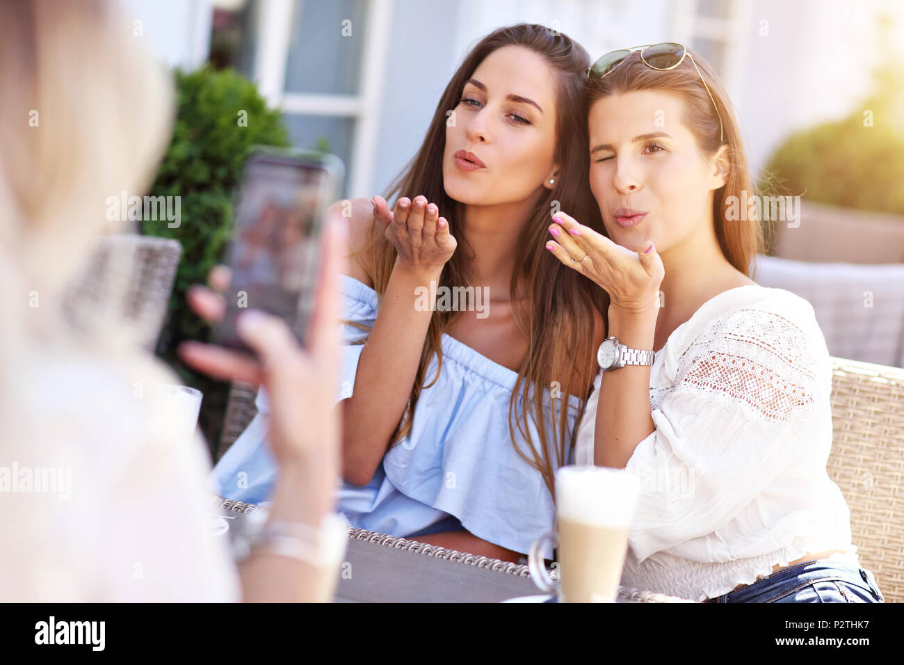 Happy girl friends hanging out in the city in summer Stock Photo