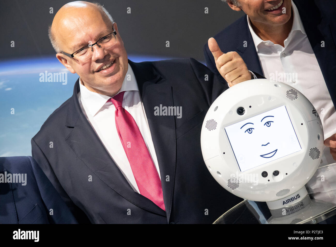 Hannover, Germany. 12th June, 2018. IT-expo CEBIT 2018 opening walk with Peter Altmaier, Federal Minister for Economic Affairs and Energy Germany. Here at IBM booth, presenting robot CIMON (Crew Interactive Mobile CompaniON), an intelligent, mobile and interactive astronaut assistance system, developed by Airbus on behalf of German Aerospace Center (DLR), using IBM Watson technology, tested on ISS as part of Horizons mission of European Space Agency (ESA). Credit: Christian Lademann Stock Photo