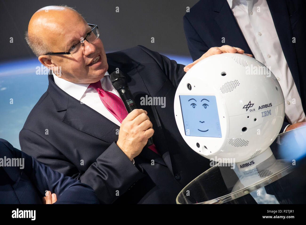 Hannover, Germany. 12th June, 2018. IT-expo CEBIT 2018 opening walk with Peter Altmaier, Federal Minister for Economic Affairs and Energy Germany. Here at IBM booth, presenting robot CIMON (Crew Interactive Mobile CompaniON), an intelligent, mobile and interactive astronaut assistance system, developed by Airbus on behalf of German Aerospace Center (DLR), using IBM Watson technology, tested on ISS as part of Horizons mission of European Space Agency (ESA). Credit: Christian Lademann Stock Photo