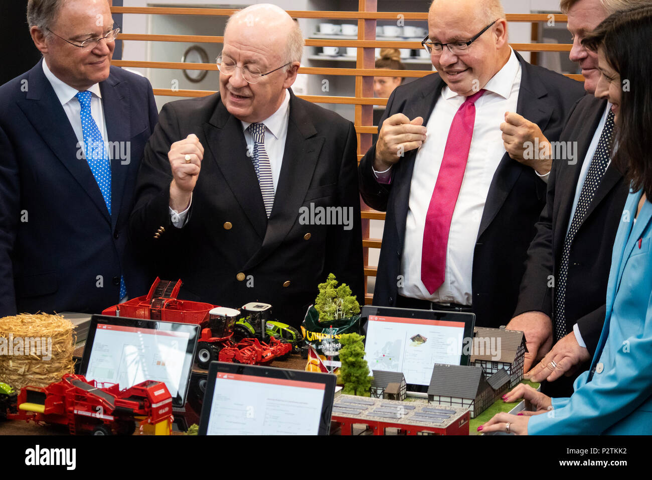 Hannover, Germany. 12th June, 2018. CEBIT 2018 opening walk with Peter Altmaier (3rd L), Federal Minister for Economic Affairs and Energy Germany. Talking about Smart Farming at booth of German Research Center for Artificial Intelligence (DFKI) with Prof. Wolfgang Wahlster (CEO DFKI, 2nd L) and Stephan Weil (Prime Minister of Lower saxony (1st L). CEBIT 2018, international computer expo and Europe's Business Festival for Innovation and Digitization. Credit: Christian Lademann Stock Photo
