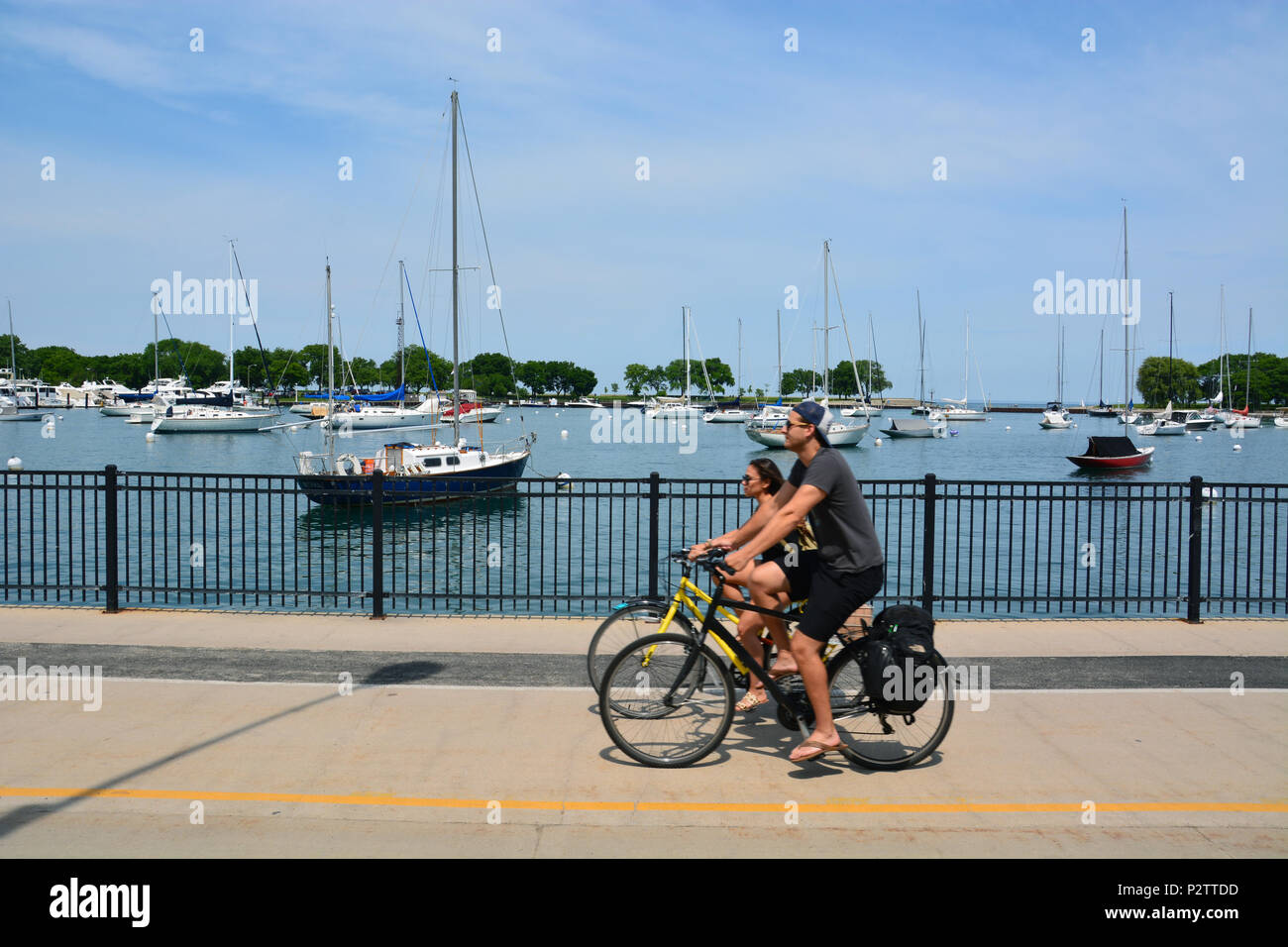 A couple rides their bikes past Belmont Harbor on Chicago's lakefront