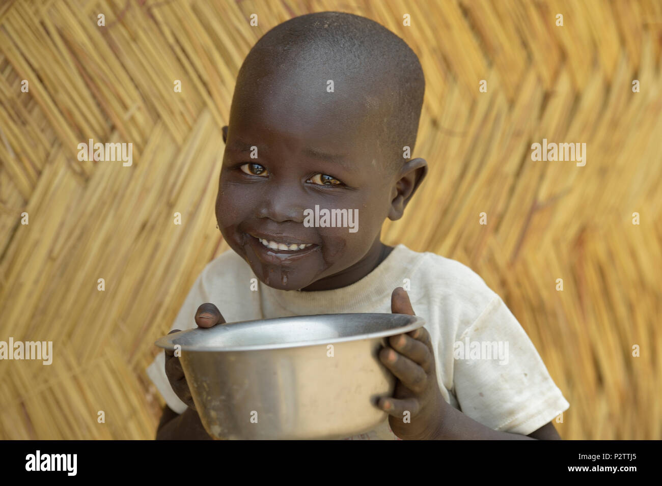 A child enjoys safe water in Malek Miir, a village in South Sudan's Lol State where a persistent drought has destroyed crops and left people hungry. Stock Photo