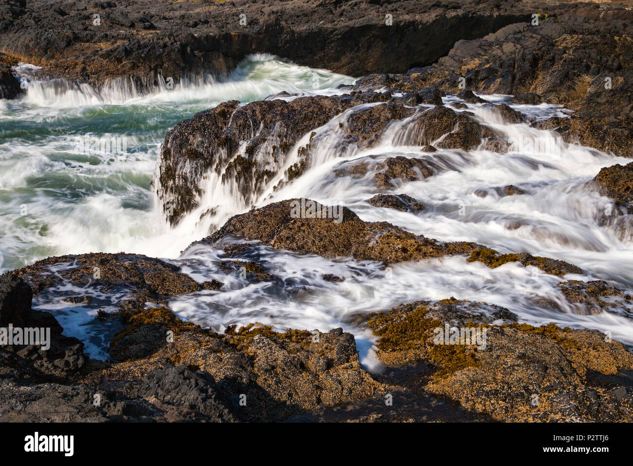 Water surges from tidal action at Cape Perpetua Scenic Area along Oregon's Central Coast south of Yachats. Stock Photo