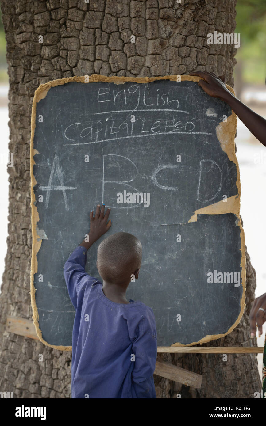 A boy points to letters on a blackboard in the Loreto Primary School in Rumbek, South Sudan. Stock Photo