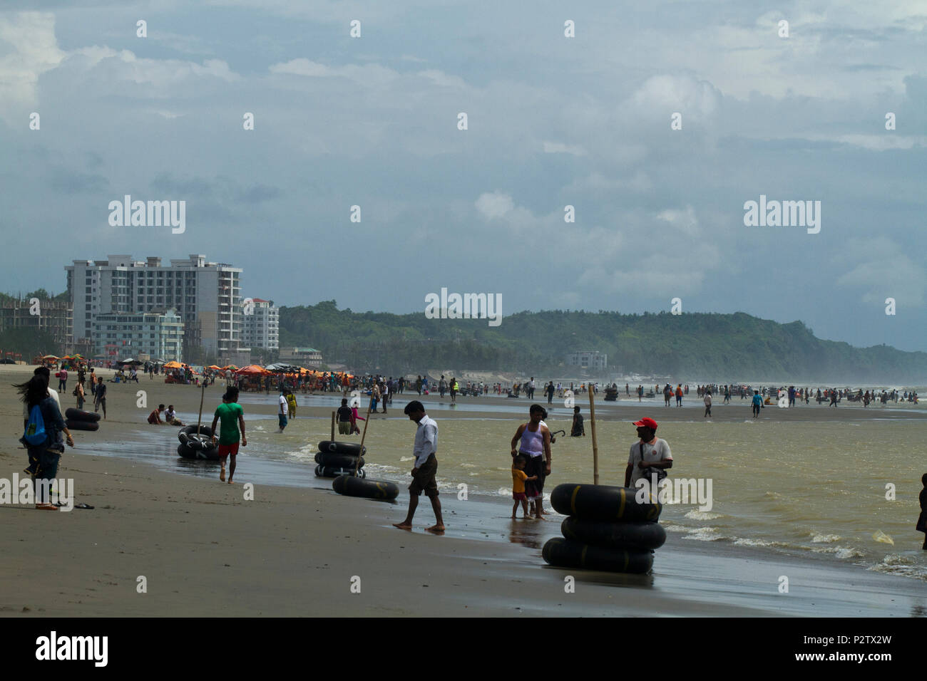 Tourists at the Cox’s Bazar Sea Beach, the longest sea beach in the world. Cox’s Bazar, Chittagong, Bangladesh. Stock Photo