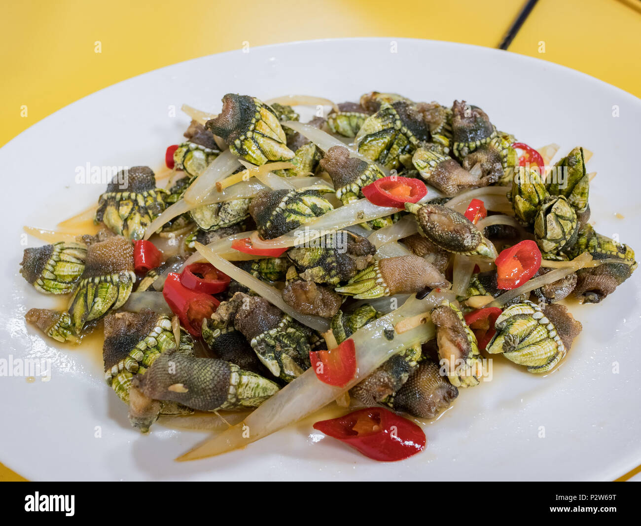 Close up shot of fry Capitulum mitella with red pepper, ate at Matsu, Taiwan Stock Photo