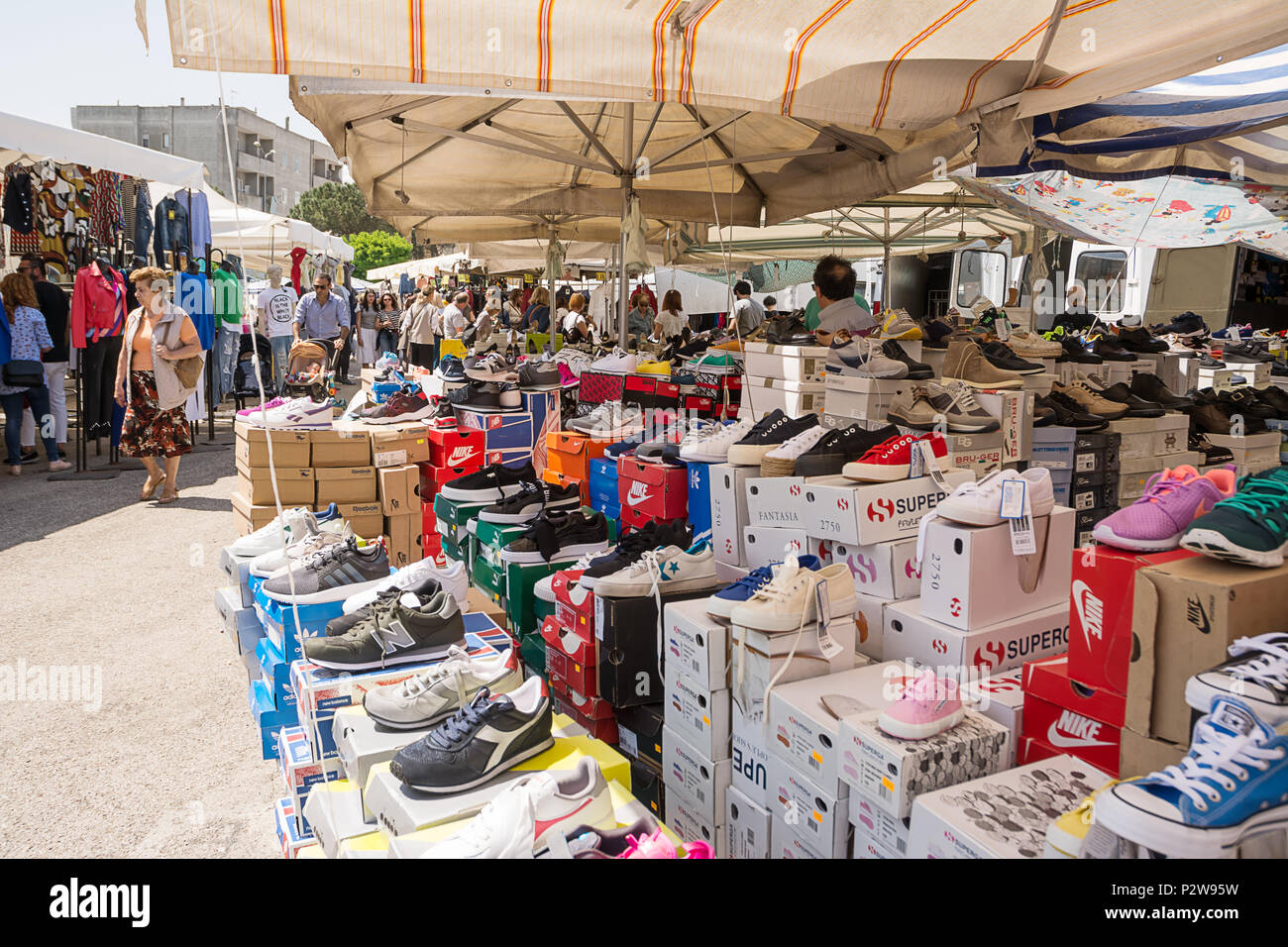 Ostuni, Italy - 28 april 2018: Stalls with shoes for sale and customers at the market of Ostuni (Italy) Stock Photo