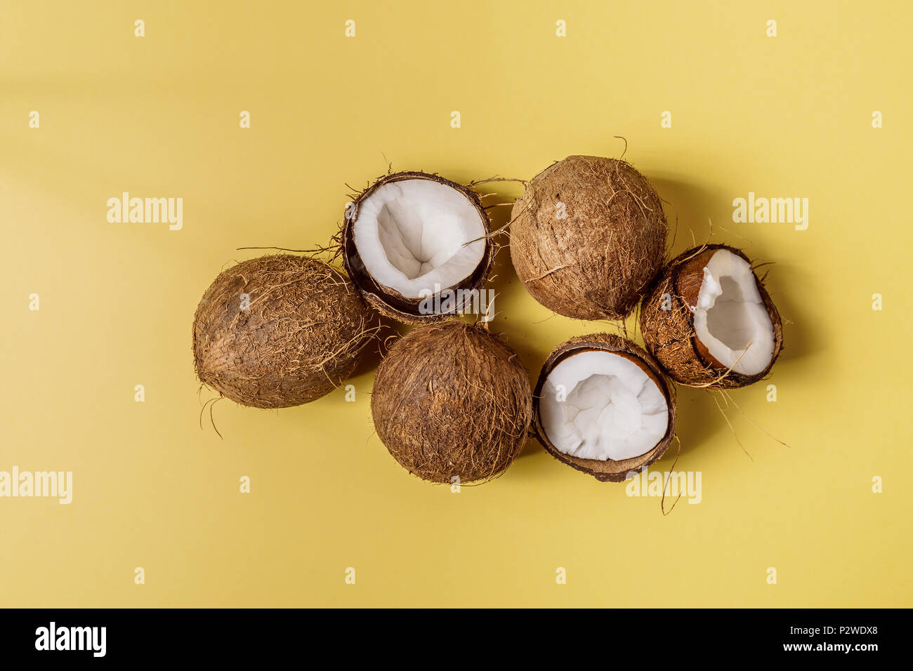 Coconuts on a pastel background, top view. Stock Photo