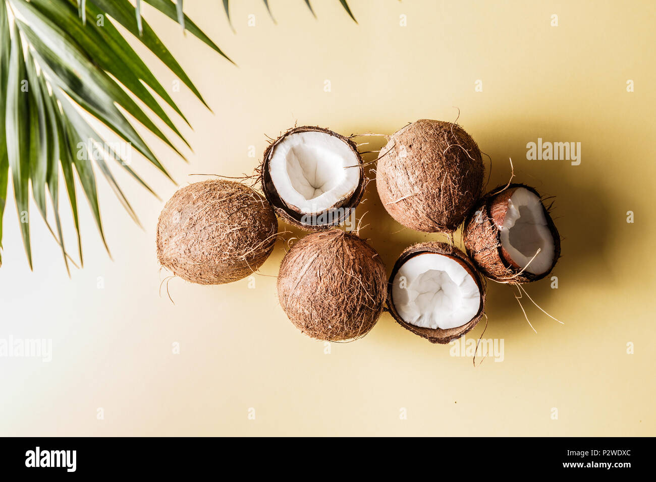 Coconuts on a pastel background, top view. Stock Photo