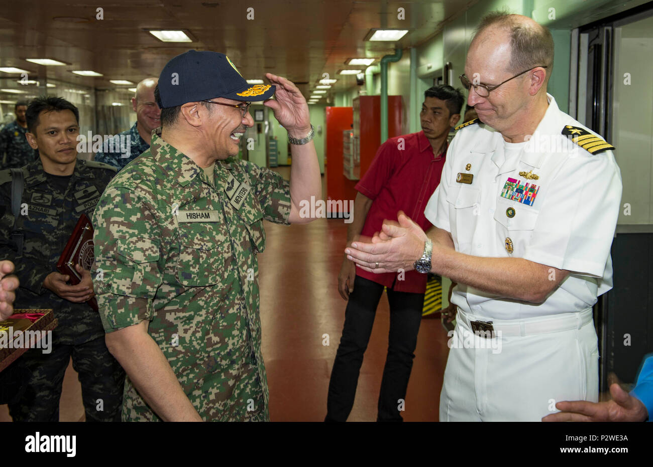160804-N-QW941-350 KUANTAN, Malaysia (Aug 4, 2016) Capt. Tom Williams (right), mission commander, Pacific Partnership 2016, presents Dato’ Seri Hishammuddin Tun Hussein, Minister of Defense, Malaysia, with a Pacific Partnership hat prior to his departure of hospital ship USNS Mercy (T-AH 19). While aboard Mercy, Hishammuddin met with Pacific Partnership personnel, toured the ship and participated in a press conference. This is the first time Mercy and Pacific Partnership have visited Malaysia. During the mission stop partner nations work side-by-side with local military and civilian organizati Stock Photo