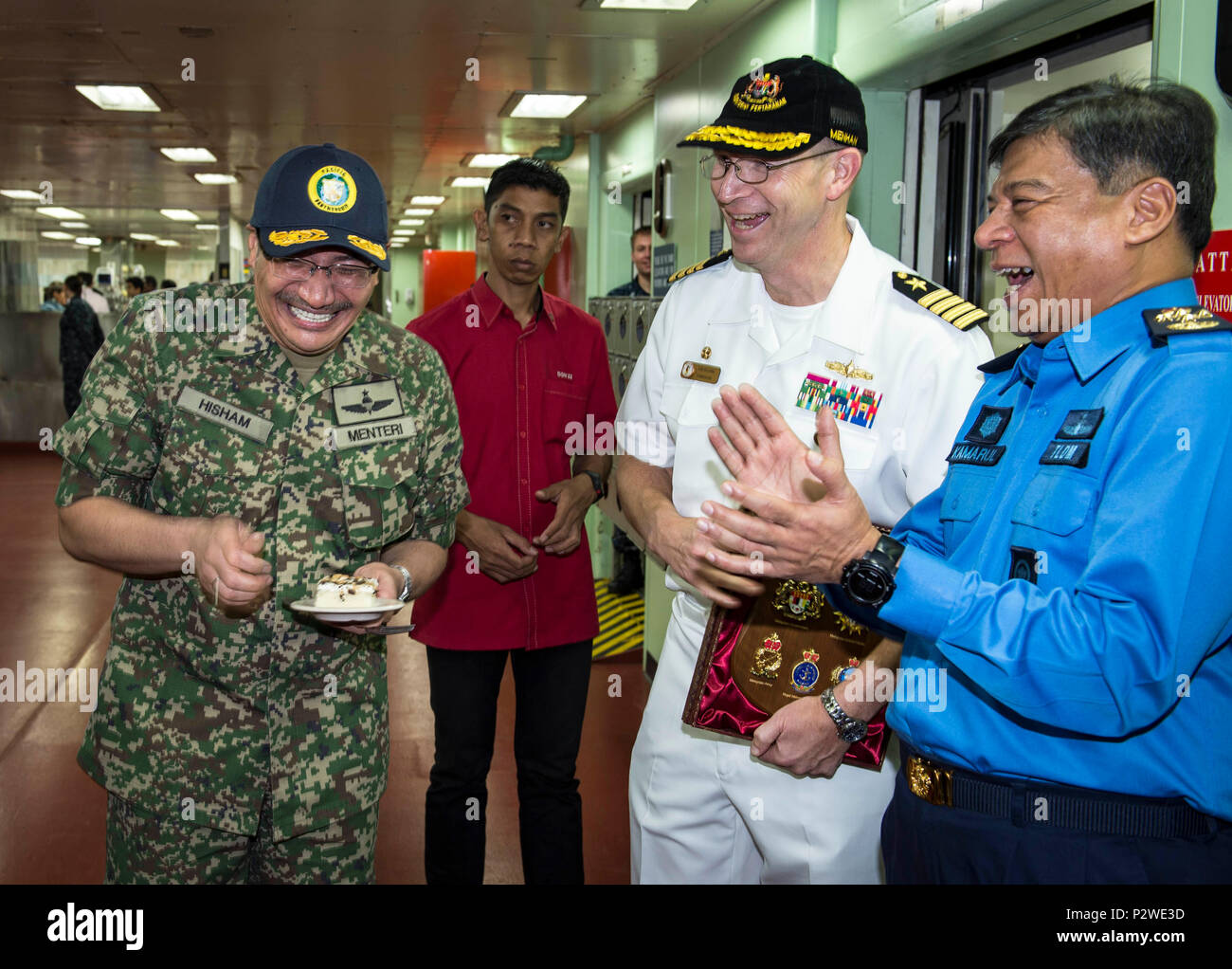 160804-N-QW941-382 KUANTAN, Malaysia (Aug 4, 2016) Dato’ Seri Hishammuddin Tun Hussein (left), Minister of Defense, Malaysia, is given a cake in celebration of his birthday while aboard hospital ship USNS Mercy (T-AH 19). While aboard Mercy, Hishammuddin met with Pacific Partnership personnel, toured the ship and participated in a press conference. This is the first time Mercy and Pacific Partnership have visited Malaysia. During the mission stop partner nations work side-by-side with local military and civilian organizations in a search and rescue exercise, civil engineering projects, communi Stock Photo