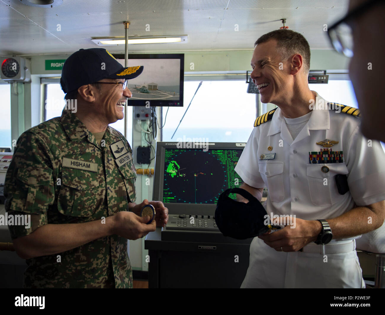 160804-N-QW941-465 KUANTAN, Malaysia (Aug 4, 2016) Capt. Peter Roberts (right), commanding officer, Medical Treatment Facility, USNS Mercy (T-AH 19) exchanges gifts with Dato’ Seri Hishammuddin Tun Hussein, Minister of Defense, Malaysia, aboard Mercy. While aboard Mercy, Hishammuddin met with Pacific Partnership personnel, toured the ship and participated in a press conference. This is the first time Mercy and Pacific Partnership have visited Malaysia. During the mission stop partner nations work side-by-side with local military and civilian organizations in a search and rescue exercise, civil Stock Photo
