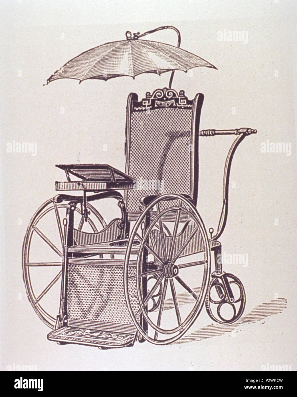 Wheelchair with writing desk and umbrella Stock Photo - Alamy