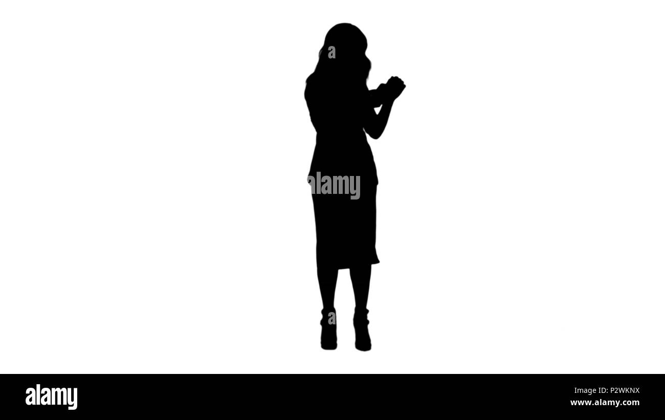 Silhouette Beautiful asian girl with smartphone singing and dancing while listening to music track matte Stock Photo