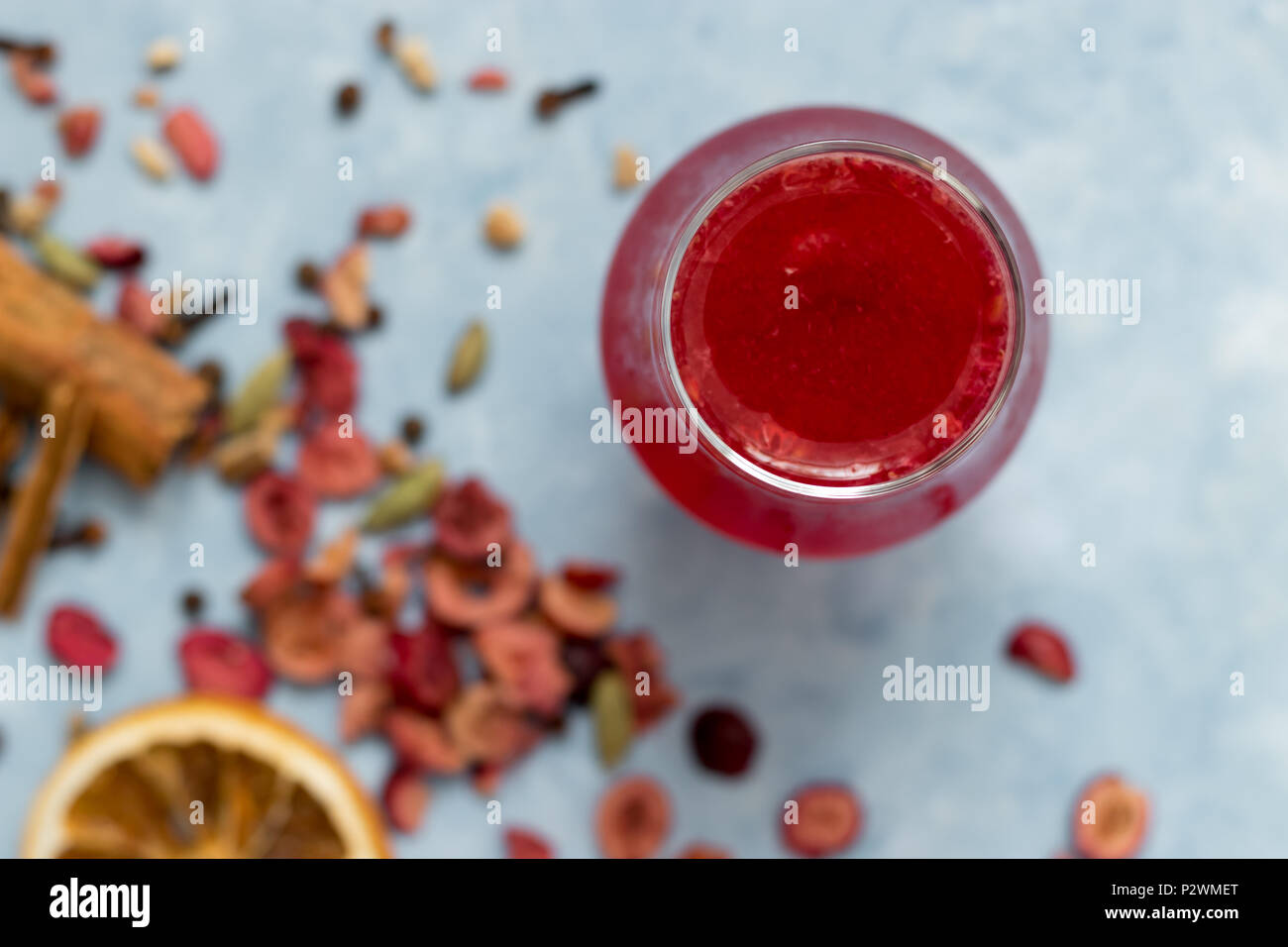 Refreshing summer drink: raspberry and mulled wine ice tea with dried spices and fruits. Stock Photo