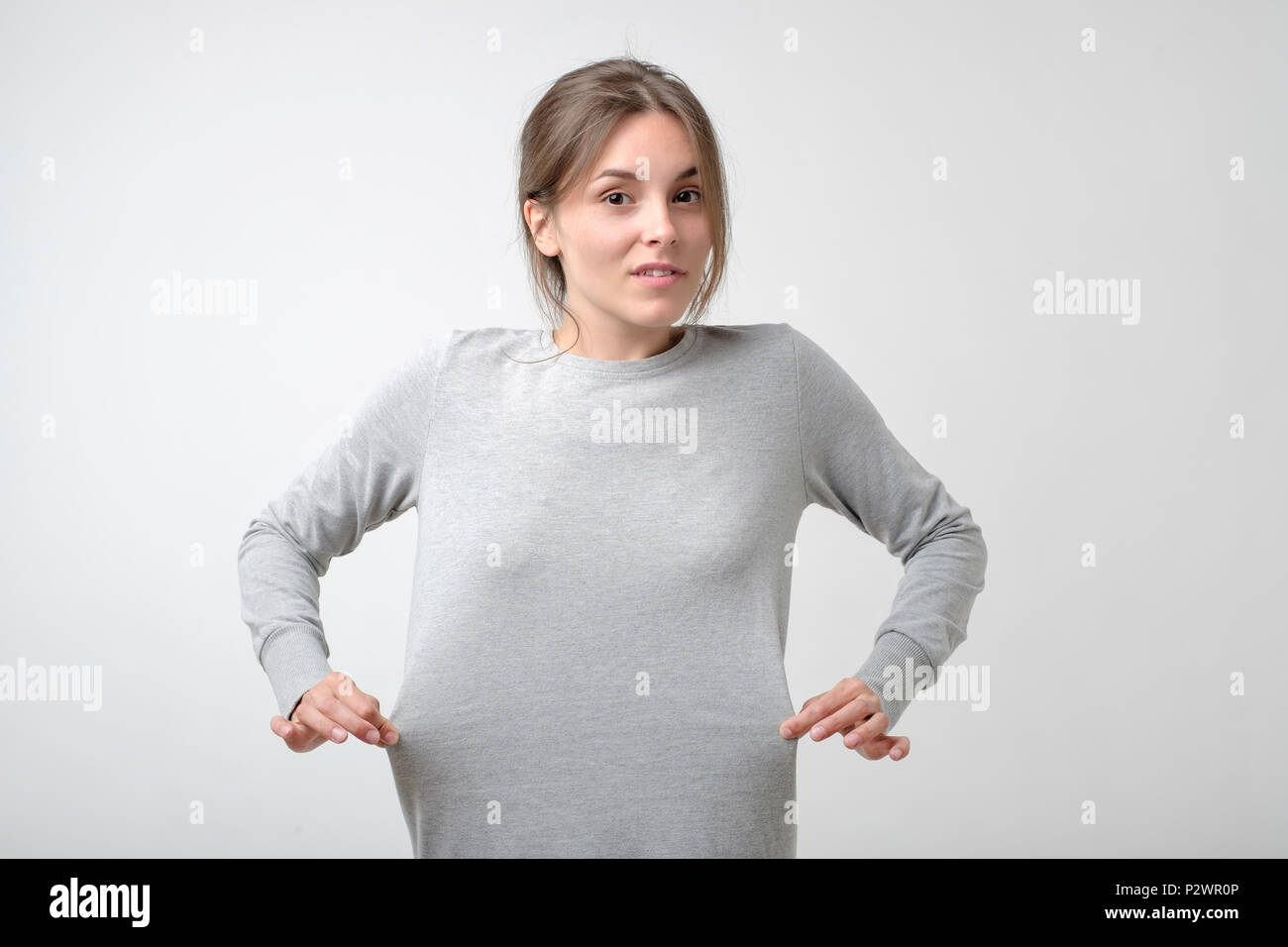 Losing weight concept. Caucasian thin woman showing that her dress is big for her. Result of diet. Stock Photo