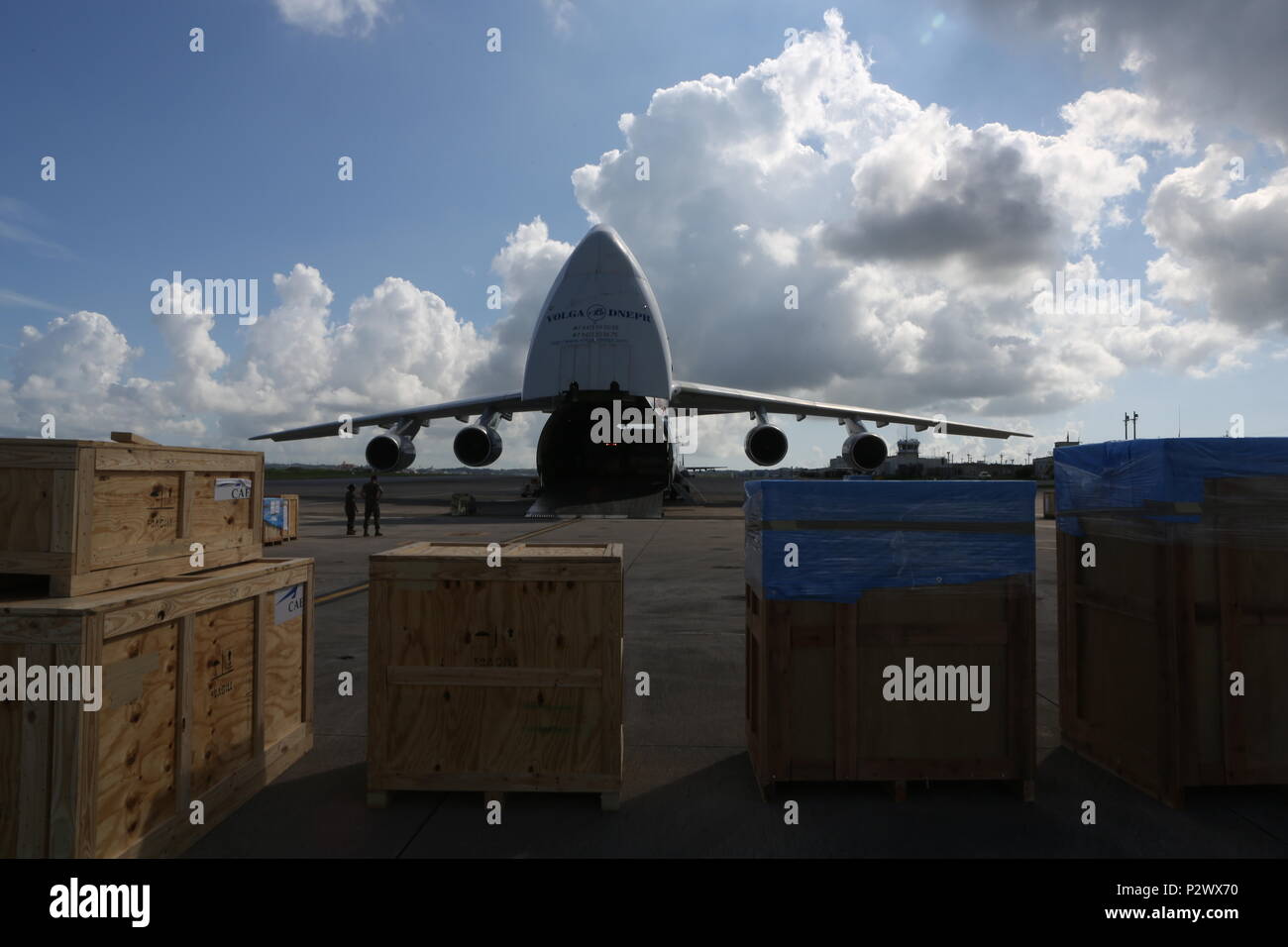 U.S. DoD members with Canadian Aviation Electronics (CAE), and Volgar-Dnepr crew members load gear at Marine Corps Air Station Futenma, August 2, 2016. CAE members work in conjunction with the Volgar-Dnepr crew members to load gear for transport to Marine Corps Air Station Iwikiuni, Japan. (U.S. Marine Corps photo by Lance Cpl. Brooke Deiters/ Released) Stock Photo