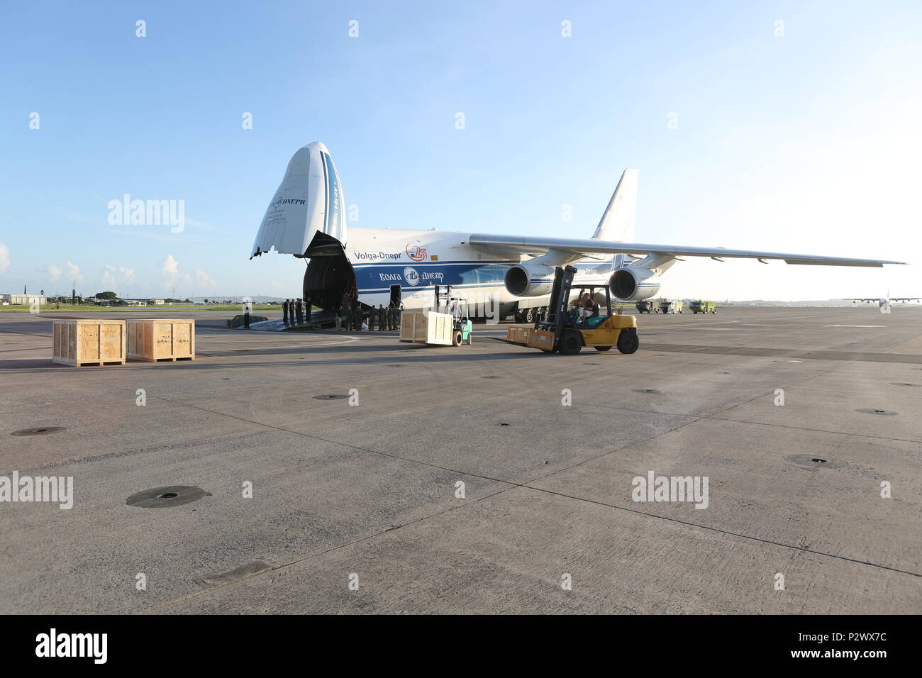 U.S. DoD members with Canadian Aviation Electronics (CAE), and Volgar-Dnepr crew members load gear at Marine Corps Air Station Futenma, August 2, 2016. CAE members work in conjunction with the Volgar-Dnepr crew members to load gear for transport to Marine Corps Air Station Iwikiuni, Japan. (U.S. Marine Corps photo by Lance Cpl. Brooke Deiters/ Released) Stock Photo