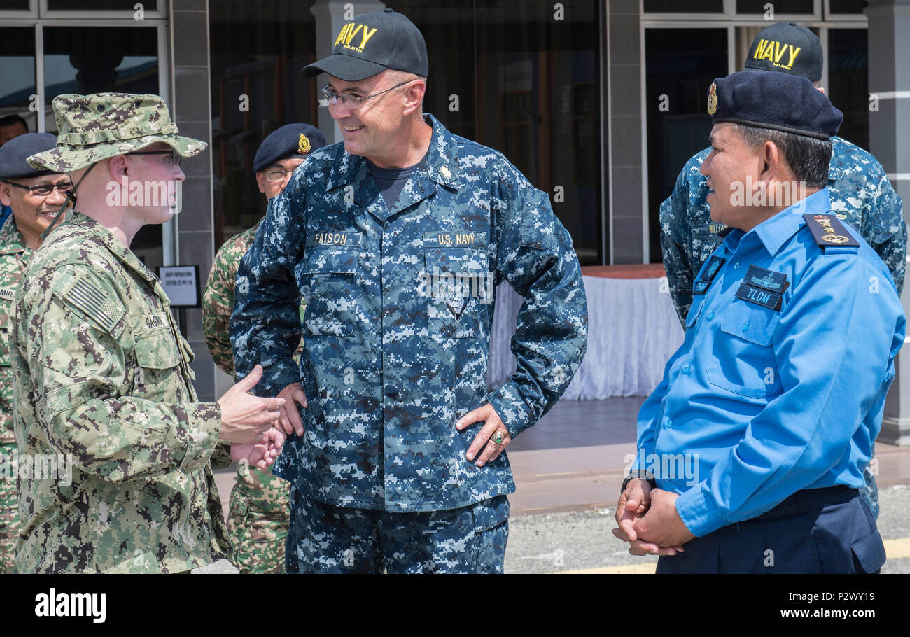 160802-N-TR165-187 KUANTAN, Malaysia (Aug 02, 2016) Cmdr. Derek Gagnon (left), director of public health for Pacific Partnership, speaks with Vice Adm. C. Forrest Faison III (center), surgeon general of the U.S. Navy, and Rear Adm. Dato' Azhari Bin Abdul Rashid, commander Naval Region 1 of the Royal Malaysian Navy, during a tour of Kuantan Naval Base after the Pacific Partnership 2016 opening ceremony. The visit marks the first time Pacific Partnership has visited Malaysia. Partner nations will work side-by-side with local military and non-government organizations to conduct cooperative health Stock Photo