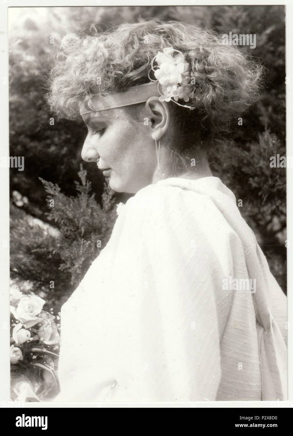 THE CZECHOSLOVAK SOCIALIST REPUBLIC - CIRCA 1980s: Vintage photo shows young woman with flowers in hair. Retro black & white  photography. Stock Photo