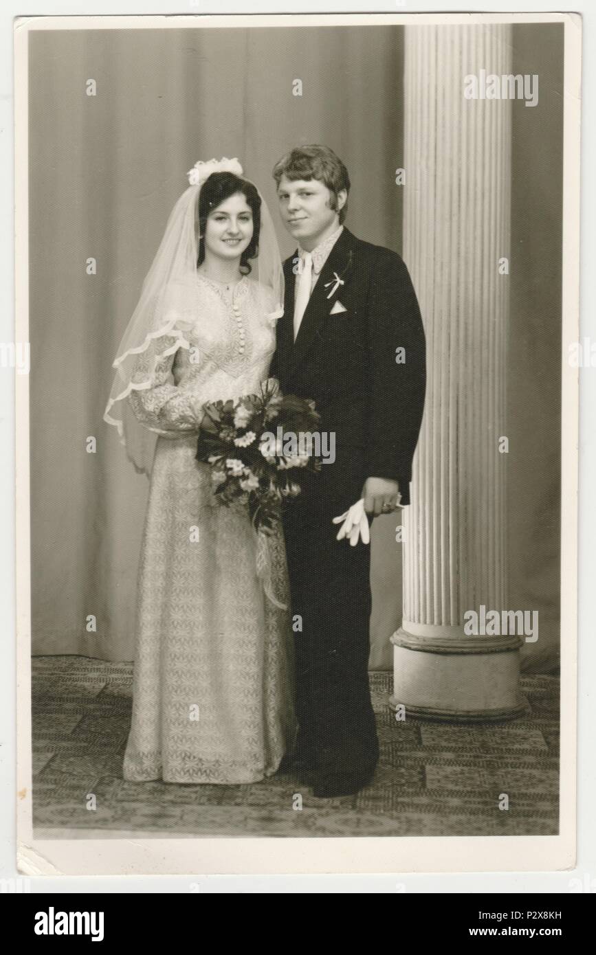 THE CZECHOSLOVAK SOCIALIST REPUBLIC - CIRCA 1980s: Vintage photo shows a bride with bridegroom. Bride wears  a soft veil and holds wedding flowers (bouquet). Retro black & white  photography. Stock Photo