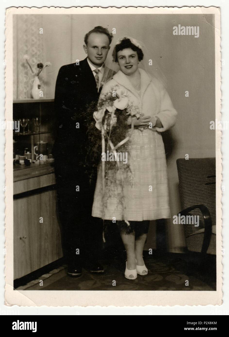 THE CZECHOSLOVAK SOCIALIST REPUBLIC - CIRCA 1960s: Vintage photo shows a bride with bridegroom. Bride wears  a soft veil and holds calla flowers (bouquet). Retro black & white  photography. Stock Photo