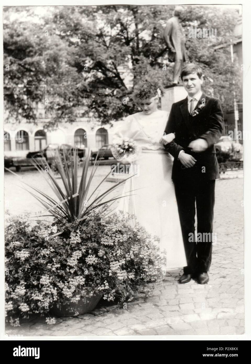 THE CZECHOSLOVAK SOCIALIST REPUBLIC - CIRCA 1980s: Vintage photo shows a bride with bridegroom. Bride holds wedding flowers (bouquet). Retro black & white  photography. Stock Photo