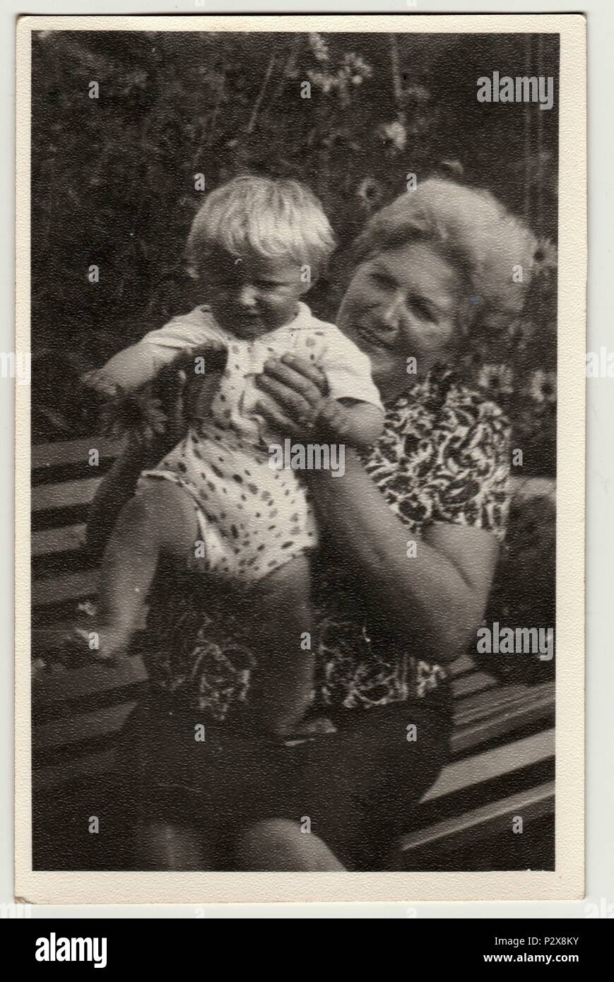 THE CZECHOSLOVAK SOCIALIST REPUBLIC - CIRCA 1950s: Vintage photo shows grandmother holds a small baby. Retro black & white  photography Stock Photo
