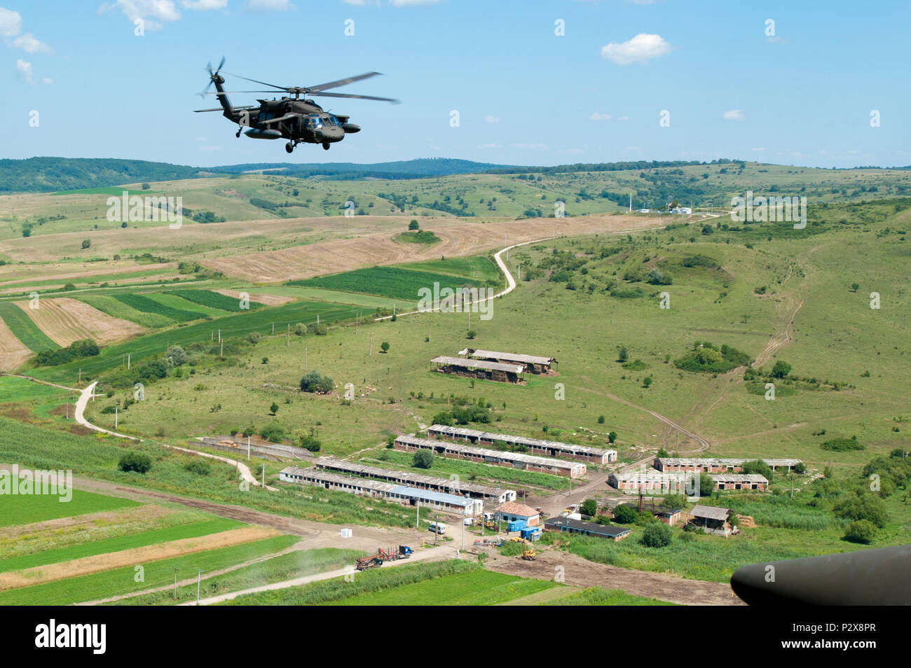 A flight crew with Company C, 3rd Battalion, 501st Aviation Regiment from Ft. Bliss, Texas fly near the Romanian Land Forces Combat Training Center in Cincu, Romania during Exercise Saber Guardian 16, August 5. Saber Guardian is a multinational military exercise involving approximately 2,800 military personnel from ten nations including Armenia, Azerbaijan, Bulgaria, Canada, Georgia, Moldova, Poland, Romania, Ukraine and the U.S. (U.S. Army photo by Staff Sgt. Kyle J. Warner, 116th Cavalry Brigade Combat Team Public Affairs). Stock Photo