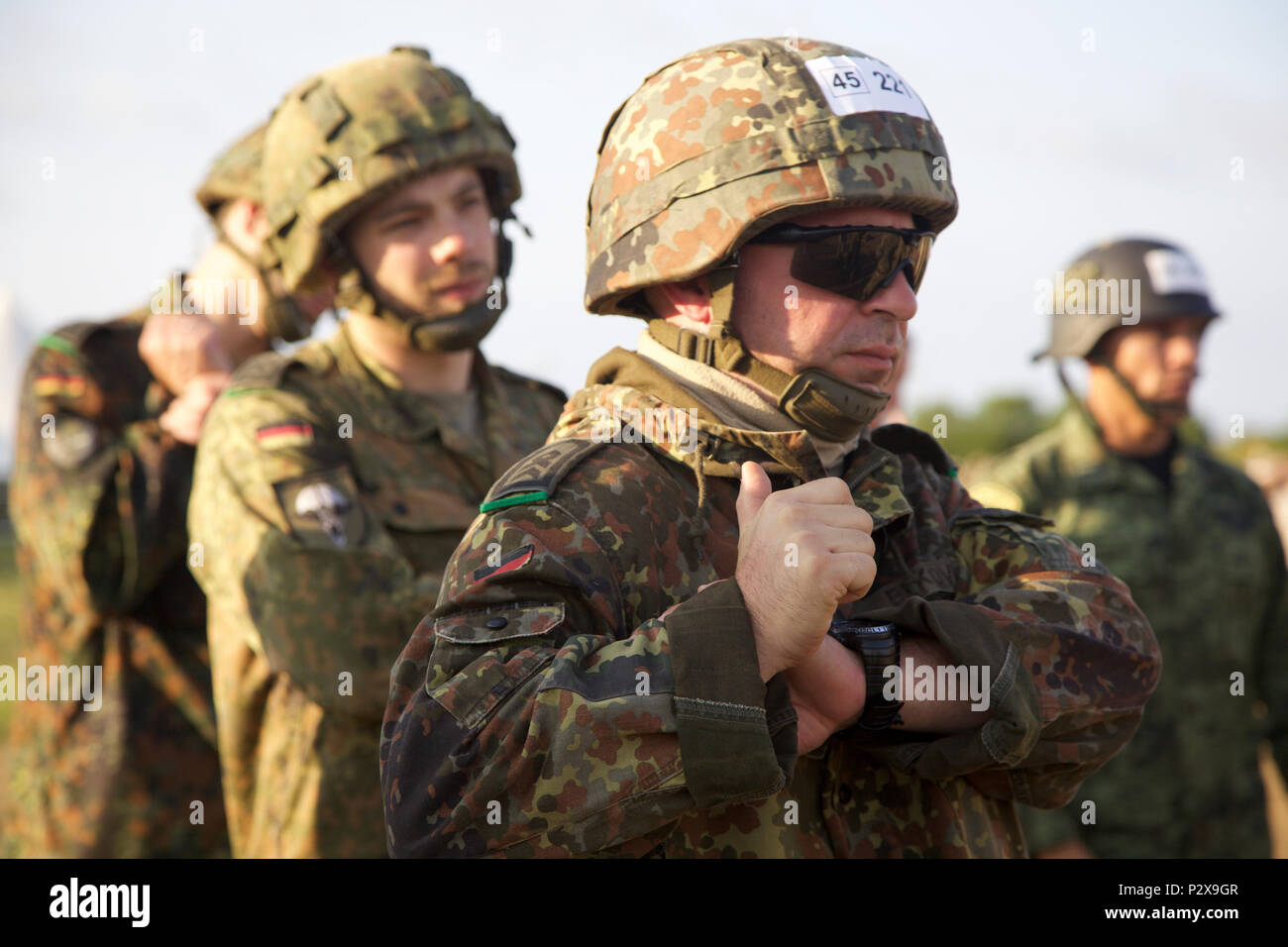 A group of German Paratroopers conducts pre-jump operations during Leapfest 2016 at the University of Rhode Island, West Kingston, R.I., August 6, 2016. Leapfest is the largest, longest standing, international static line parachute training event and  competition hosted by the 56th Troop Command, Rhode Island Army National Guard to promote high level technical training and esprit de corps within the International Airborne community. (U.S. Army photo by Sgt. Austin Berner/Released) Stock Photo