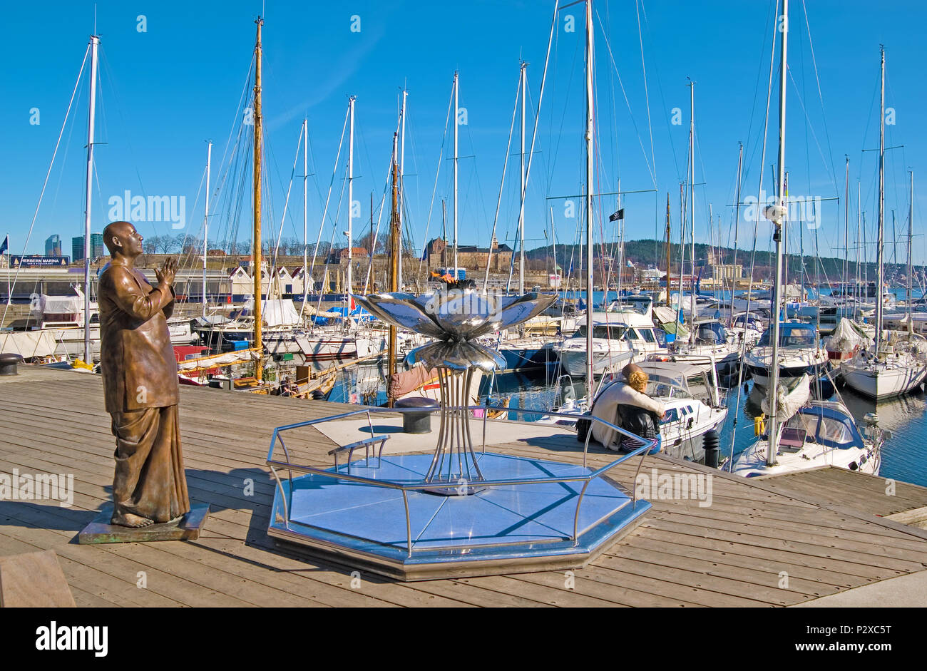 OSLO, NORWAY - APRIL 12, 2010: Stranden. Sculpture Eternal Peace-Flame with Sri Chinmoy on Aker Brygge area Stock Photo