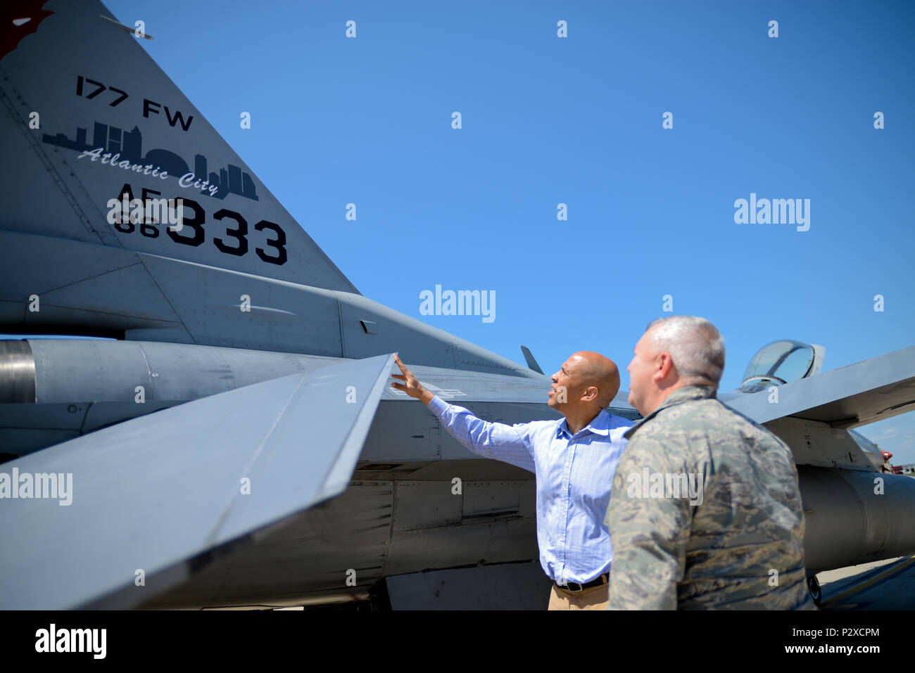U.S. Sen. Cory Booker and the Adjutant General of the New Jersey National Guard, Brig. Gen. Michael L. Cunniff, discuss the flight parameters of an F-16 fighter jet during a visit to the 177th Fighter Wing in Egg Harbor Township, N.J. on Aug. 5, 2016. It was the first visit to the New Jersey Air National Guard base by Sen. Booker, who received a briefing by the Wing Commander, U.S. Air Force Col. John R. DiDonna, flew an F-16 simulator and got a chance to get an up close look at an F-16C Fighting Falcon fighter jet on the flight line at the Atlantic City Air National Guard base. (U.S. Air Nati Stock Photo