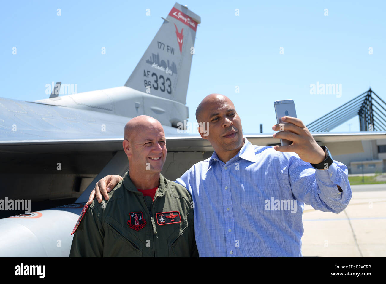 Cory Booker, U.S. Senator from New Jersey, records a Snapchat with U.S. Air Force Col. John R. DiDonna, Wing Commander of the New Jersey National Guard's 177th Fighter Wing, during a visit to the Wing in Egg Harbor Township, N.J. on Aug. 5, 2016. It was the first visit to the New Jersey Air National Guard base by Sen. Booker, who received a briefing by DiDonna, flew an F-16 simulator and got a chance to get an up-close look at the Wing jet on the flight line at the Atlantic City Air National Guard base. (U.S. Air National Guard photo by Master Sgt. Andrew J. Moseley/Released) Stock Photo