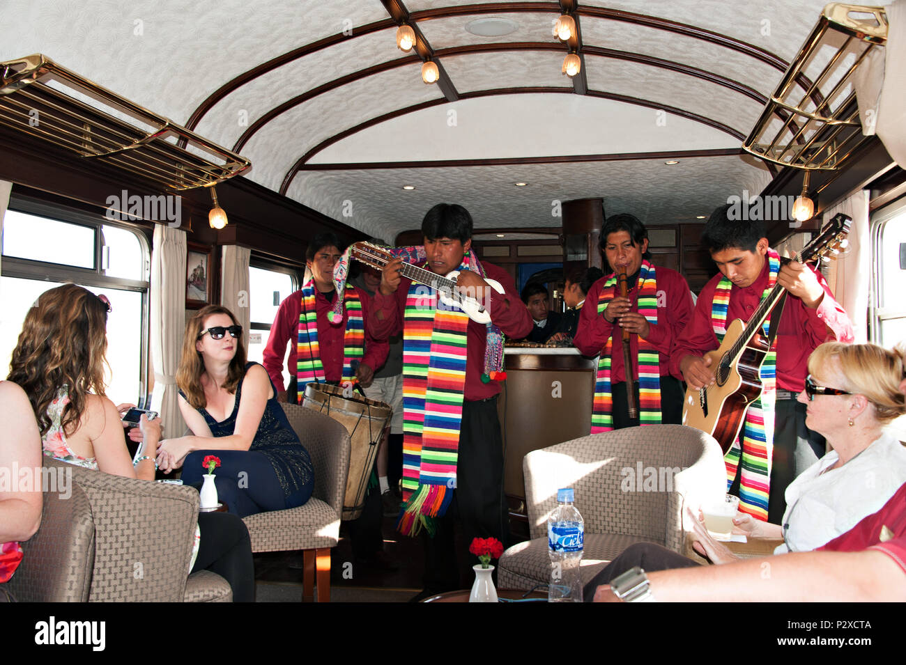 Tourist entertainment by a peruvian band playing music on the moving